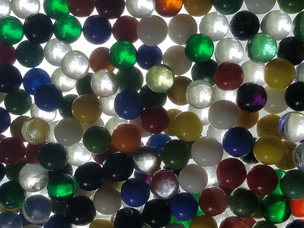 marbles illuminated by light coming from behind them